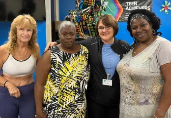 Four women involved with the Healthy You Initiative pose for a photo inside the Greater Ridgecrest YMCA.