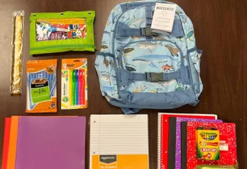 backpack and school supplies laid flat on the table