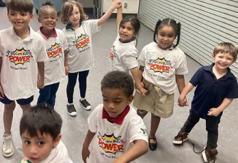 Children wearing 'KIDS POWER' shirts at Skycrest