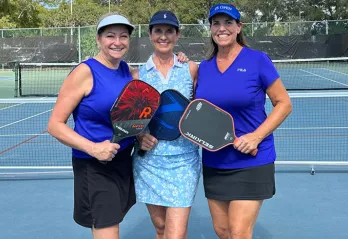 Kat Orr, Kelly Westbrook and Robbie McKee pose for a photo at the John Geigle YMCA pickleball courts. 