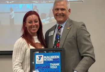 Maureen Peters receiving her congratulary certificate from Scott Goyer