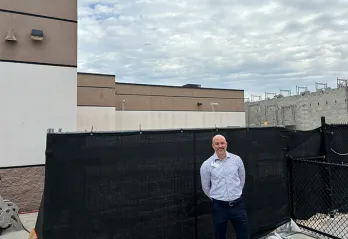 Seth Mildebrand in front of YMCA construction.