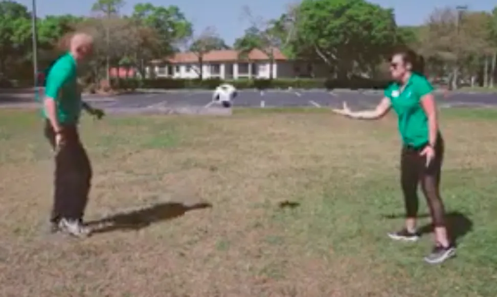 two y staff doing a soccer drill