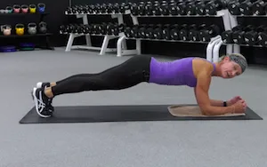 exercise instructor demonstrating plank on elbows