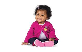baby girl wearing pink sitting on floor