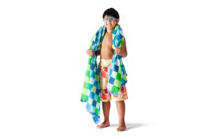 boy wearing bathing suit wearing goggles and towel