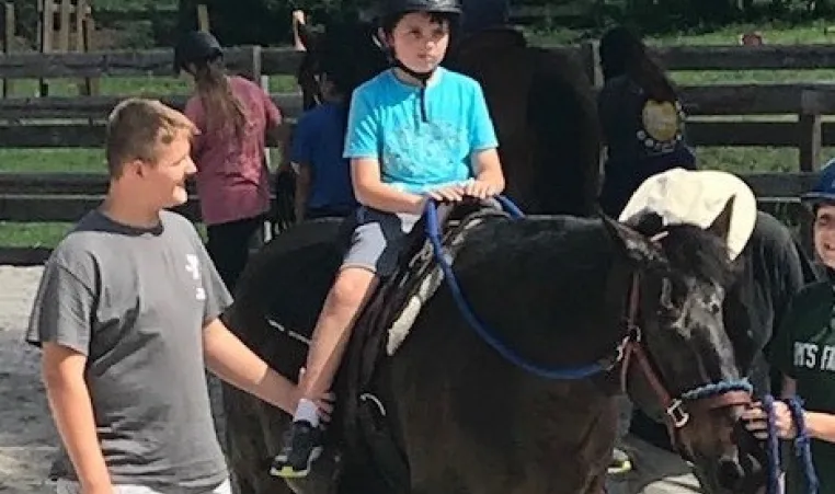 camp coast camper liam on a horse