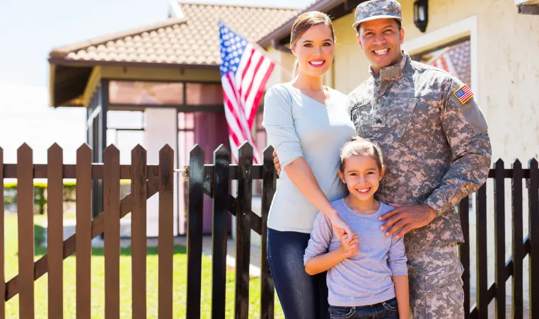 military dad posing with wife and daughter