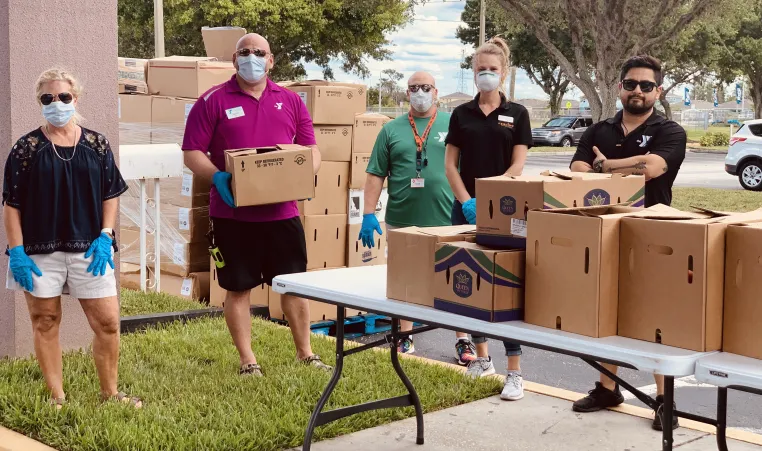 The YMCA of the Suncoast's West Pasco branch, located at 8411 Photonics Dr. in Trinity, works with Feeding Tampa Bay to hand out food to needy families on April 6, 2020. 