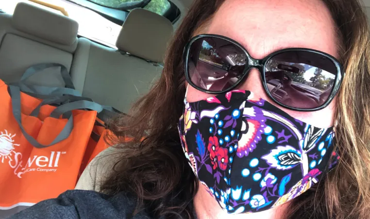 woman wearing mask in car