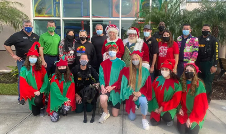 elves and police officer outside the ymca