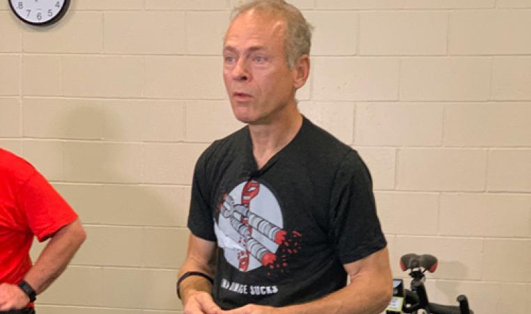 YMCA Pedaling for Parkinson's participant sits on a cycling bike