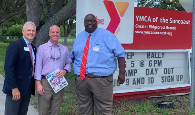 YMCA of the Suncoast CEO, State Representative Nick DiCeglie and Director Brad Barnes outside the YMCA of the Ridgecrest red marquee