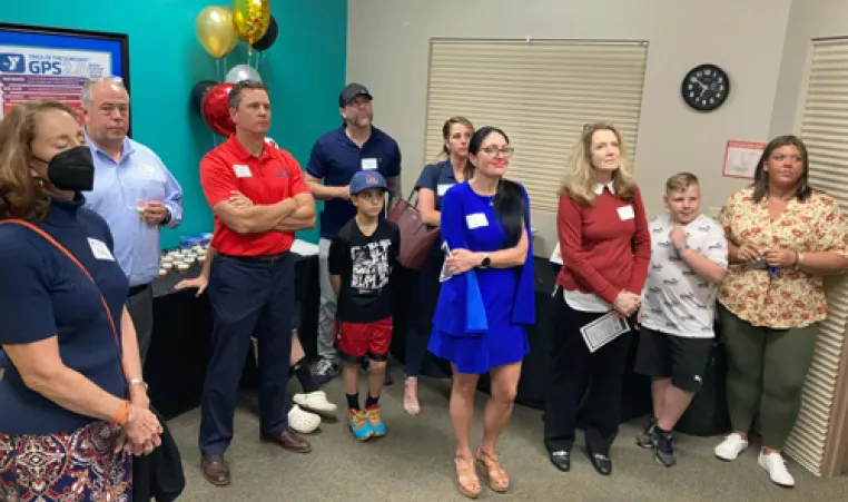 Group of eight adults and two children listen to Y stories at the Greater Palm Harbor YMCA.