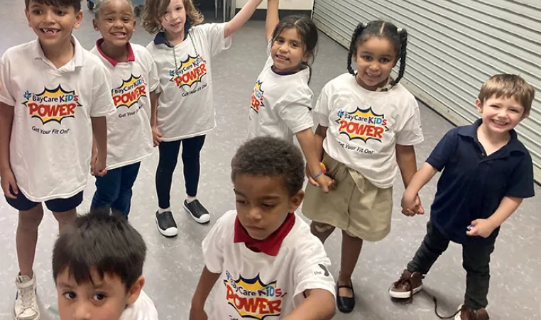 Children wearing 'KIDS POWER' shirts at Skycrest