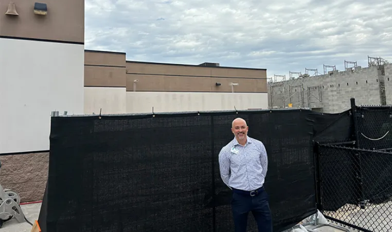 Seth Mildebrand in front of YMCA construction.