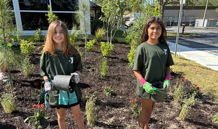 Two students celebrate Earth Day at the Greater Palm Harbor YMCA.