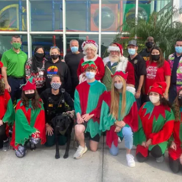 elves and police officer outside the ymca