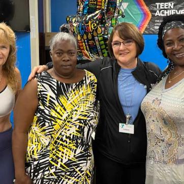 Four women involved with the Healthy You Initiative pose for a photo inside the Greater Ridgecrest YMCA.