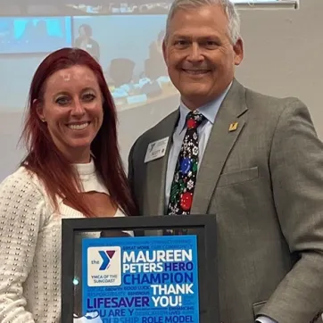 Maureen Peters receiving her congratulary certificate from Scott Goyer