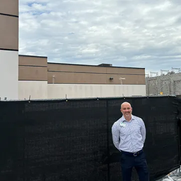 Seth Mildebrand in front of YMCA construction.
