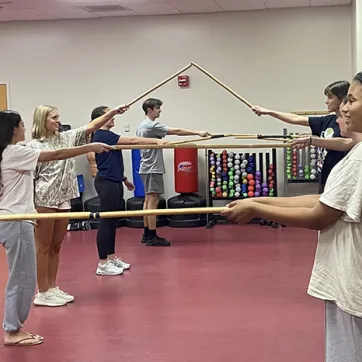 Students participating in the Stick Club at the John Geigle YMCA