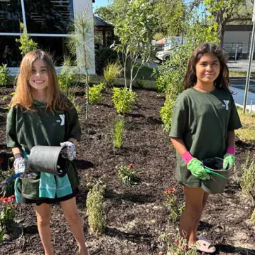 Two students celebrate Earth Day at the Greater Palm Harbor YMCA.