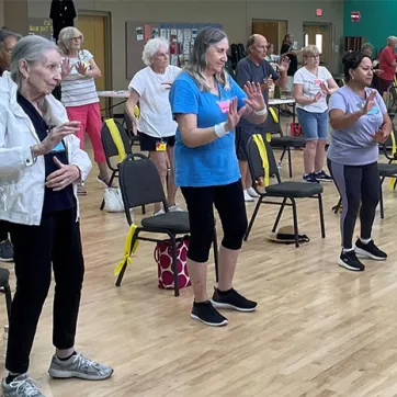 Seniors practicing Tai Chi indoors at the Hernando County YMCA.