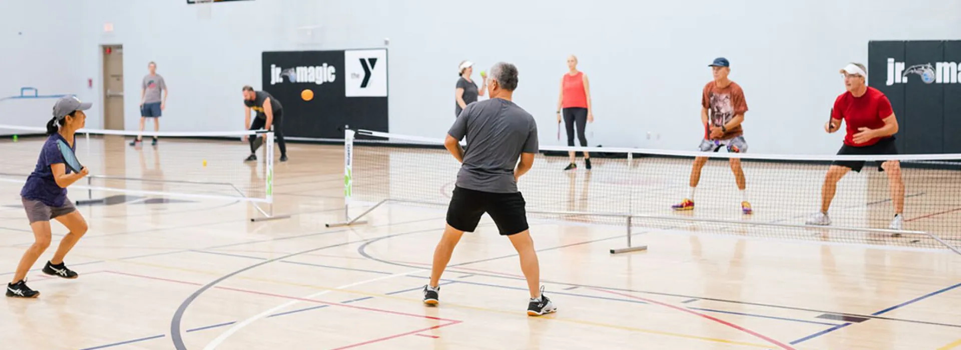 Adults playing tennis at the YMCA.