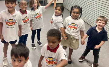 Children wearing 'KIDS POWER' shirts at Skycrest