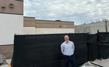 Seth Mildebrand in front of YMCA construction.